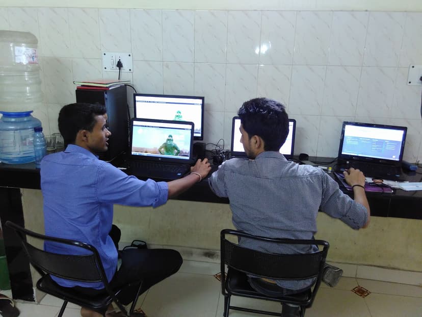 Two colleagues working at desks with multiple monitors at Finch Technologies