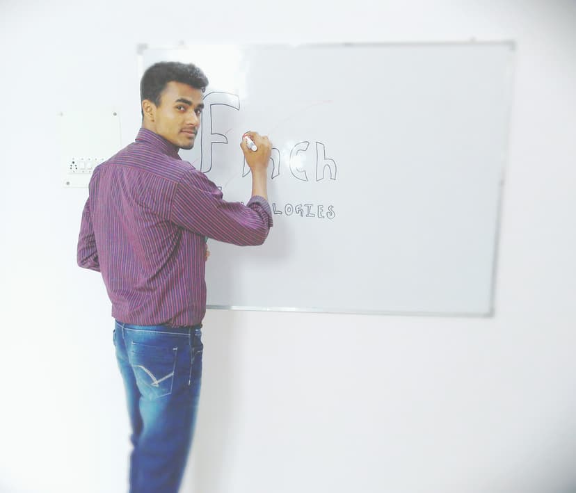 Rahul Maurya drawing the Finch Technologies logo on a whiteboard