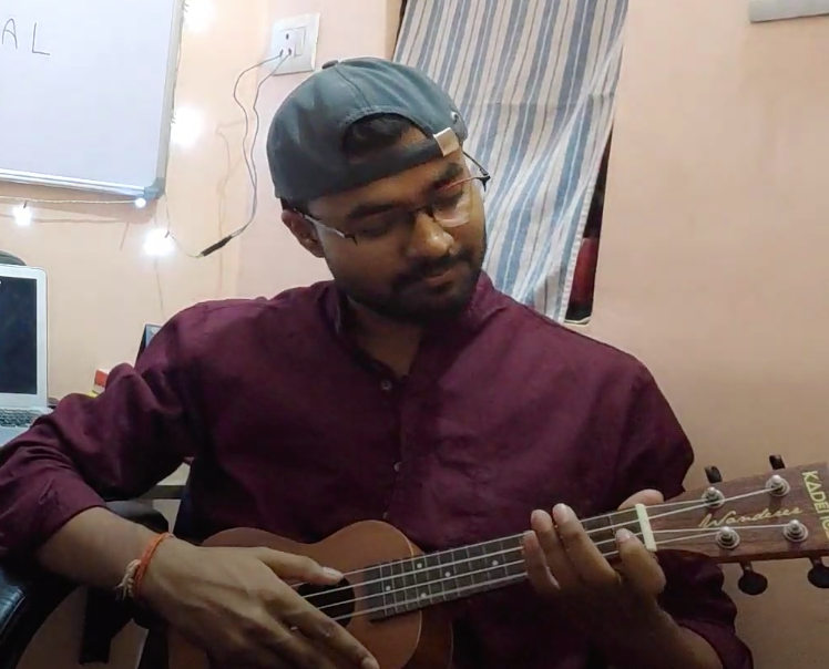 Rahul Maurya playing the ukulele at home